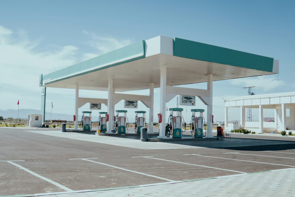 Modern fuel station forecourt with pump islands under a wide canopy